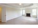 Spacious bedroom featuring a fireplace, tray ceiling, and ample natural light at 3455 Dalwood Dr, Suwanee, GA 30024