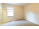 Sunlit bedroom boasting neutral carpet and a large window with bright natural light at 3455 Dalwood Dr, Suwanee, GA 30024