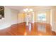 Elegant dining room with hardwood floors, classic chandelier, and wainscoting details at 3455 Dalwood Dr, Suwanee, GA 30024