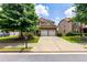 Charming two-story house with a well-manicured lawn, double garage and a long concrete driveway at 3455 Dalwood Dr, Suwanee, GA 30024