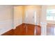 Bright foyer with hardwood floors, white trim, and a traditional entry door with sidelights at 3455 Dalwood Dr, Suwanee, GA 30024