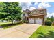 Attractive two-story home featuring a manicured lawn, driveway, and stone accents at 3455 Dalwood Dr, Suwanee, GA 30024