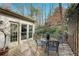 Outdoor deck featuring a table with chairs, potted plants, and views of the wooded yard at 3923 Ashford Ne Trl, Brookhaven, GA 30319