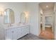 Bright bathroom featuring double vanity, marble floors, and access to the main bedroom at 3923 Ashford Ne Trl, Brookhaven, GA 30319