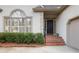 Stately front entrance with brick steps, black door, and manicured shrubbery at 3923 Ashford Ne Trl, Brookhaven, GA 30319