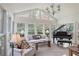 Light-filled sunroom with large windows and a grand piano at 3923 Ashford Ne Trl, Brookhaven, GA 30319