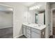 Upstairs bathroom featuring double sink vanity, neutral finishes and access to bedroom at 5063 Lower Elm St, Atlanta, GA 30349