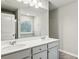 Well-lit bathroom featuring a double sink vanity, large mirror, and neutral color palette at 5063 Lower Elm St, Atlanta, GA 30349