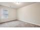 A bright carpeted bedroom features a window, perfect for relaxation and rest at 5063 Lower Elm St, Atlanta, GA 30349