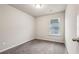 A cozy carpeted bedroom features a window providing natural light at 5063 Lower Elm St, Atlanta, GA 30349