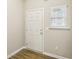 Bright entryway with a white door, window with blinds, and hardwood floors at 5063 Lower Elm St, Atlanta, GA 30349