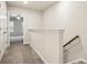 Upstairs hallway with carpeted floors leading to a room with a ceiling fan at 5063 Lower Elm St, Atlanta, GA 30349