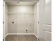 A laundry room with hardwood floors and convenient hookups at 5063 Lower Elm St, Atlanta, GA 30349