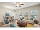 Bright living room and dining room with hardwood floors, modern furnishings, and natural light at 5063 Lower Elm St, Atlanta, GA 30349