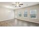 Open-concept living space with many windows, ceiling fan, and luxury vinyl flooring at 5063 Lower Elm St, Atlanta, GA 30349