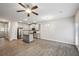 Open-concept living space with kitchen, pendant lights, ceiling fan, and luxury vinyl flooring at 5063 Lower Elm St, Atlanta, GA 30349