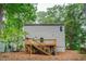 Backyard featuring a wooden deck with staircase, and plenty of tree coverage at 577 Center Hill Nw Ave, Atlanta, GA 30318