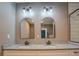 Bathroom with double vanity featuring granite countertop, modern mirrors and lighting fixtures at 577 Center Hill Nw Ave, Atlanta, GA 30318