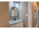 This bathroom features a granite countertop, white vanity, black faucet and a modern arched mirror at 577 Center Hill Nw Ave, Atlanta, GA 30318