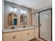 Bathroom with double vanity featuring granite countertop, modern mirrors and glass shower at 577 Center Hill Nw Ave, Atlanta, GA 30318