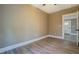 Cozy bedroom with gray flooring, white trim, tan colored walls, and a door to the hallway at 577 Center Hill Nw Ave, Atlanta, GA 30318