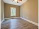 Comfortable bedroom with gray flooring, white trim, tan colored walls, and a window at 577 Center Hill Nw Ave, Atlanta, GA 30318