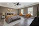 This furnished primary bedroom features a ceiling fan, two large windows, and luxury vinyl plank flooring at 577 Center Hill Nw Ave, Atlanta, GA 30318