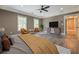 This furnished primary bedroom features a ceiling fan, two large windows, and luxury vinyl plank flooring at 577 Center Hill Nw Ave, Atlanta, GA 30318