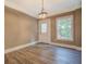 Dining room with tan colored walls, gray flooring, white trim, and a door to the backyard at 577 Center Hill Nw Ave, Atlanta, GA 30318