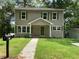 Traditional two-story home with green shutters, front porch, and a well-manicured lawn at 577 Center Hill Nw Ave, Atlanta, GA 30318