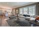 Staged living room featuring a large sofa, rug, and a view into the kitchen at 577 Center Hill Nw Ave, Atlanta, GA 30318