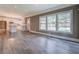 Bright, open-concept living room featuring hardwood floors, large windows, and a view into the kitchen at 577 Center Hill Nw Ave, Atlanta, GA 30318