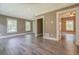 Spacious living room with gray flooring, white trim, tan colored walls, and natural lighting at 577 Center Hill Nw Ave, Atlanta, GA 30318