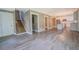 Bright, open-concept living room featuring hardwood floors, a staircase, and a view into the kitchen at 577 Center Hill Nw Ave, Atlanta, GA 30318