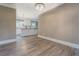 Spacious living room with white trim, gray flooring, and views of the kitchen at 577 Center Hill Nw Ave, Atlanta, GA 30318