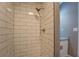 This tiled shower features white subway tile with dark grout and a chrome shower head at 577 Center Hill Nw Ave, Atlanta, GA 30318