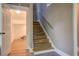 View of a staircase with wooden steps and a handrail, with a door leading to an unfinished room at 577 Center Hill Nw Ave, Atlanta, GA 30318