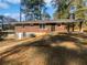 Side and rear exterior view of home featuring a carport, brickwork, and natural lighting at 1641 Rockcliff Se Pl, Atlanta, GA 30316