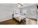 Neutral bedroom with a ceiling fan, exterior door, and wood-look flooring at 2304 Isla Run, Woodstock, GA 30188