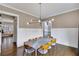 Elegant dining room with modern lighting and wainscoting at 2304 Isla Run, Woodstock, GA 30188