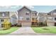 Three-story townhome with brick facade, two-car garage, and a private balcony at 2304 Isla Run, Woodstock, GA 30188