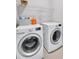 Efficient laundry room equipped with a modern, front-load washer and dryer set at 2304 Isla Run, Woodstock, GA 30188