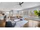 Bright living room with large windows, hardwood floors, and comfortable seating area at 2304 Isla Run, Woodstock, GA 30188