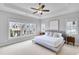 Inviting main bedroom featuring a tray ceiling, large windows and modern decor at 2304 Isla Run, Woodstock, GA 30188