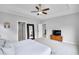 Bright and airy main bedroom featuring a ceiling fan and doorway to bathroom at 2304 Isla Run, Woodstock, GA 30188