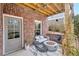 Cozy brick patio featuring a fire pit, comfortable seating, and stylish decor at 2304 Isla Run, Woodstock, GA 30188