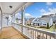 Balcony with white columns shows stunning views of the neighborhood at 2304 Isla Run, Woodstock, GA 30188