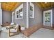 Relaxing porch featuring brick accents, outdoor seating, and stylish decor; ideal for unwinding at 2304 Isla Run, Woodstock, GA 30188