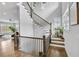 Elegant staircase with wood and iron railings and abundant natural light at 2304 Isla Run, Woodstock, GA 30188