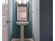 Powder room featuring stylish pedestal sink with modern faucet and gray-blue wall at 100 Duval Dr, Alpharetta, GA 30009